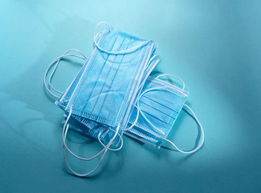 A pair of surgical masks sitting on top of a table.